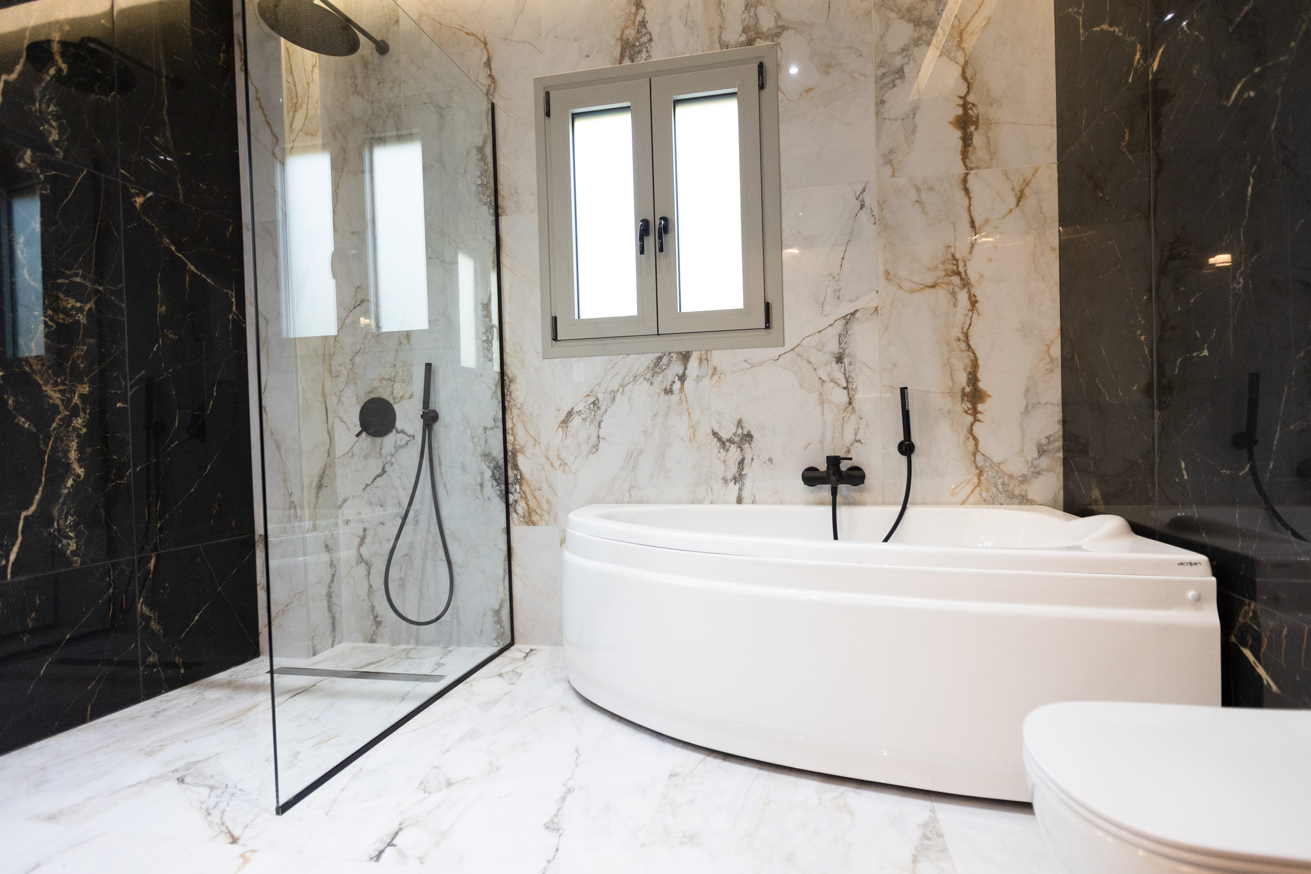 Marble bathroom with rain shower and freestanding bath at 3 bedroom Infinity Lefkas villa